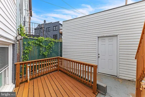 a view of a balcony with wooden floor