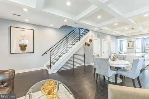 a dining room with furniture a rug and wooden floor