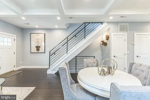 a dining room with wooden floor and furniture