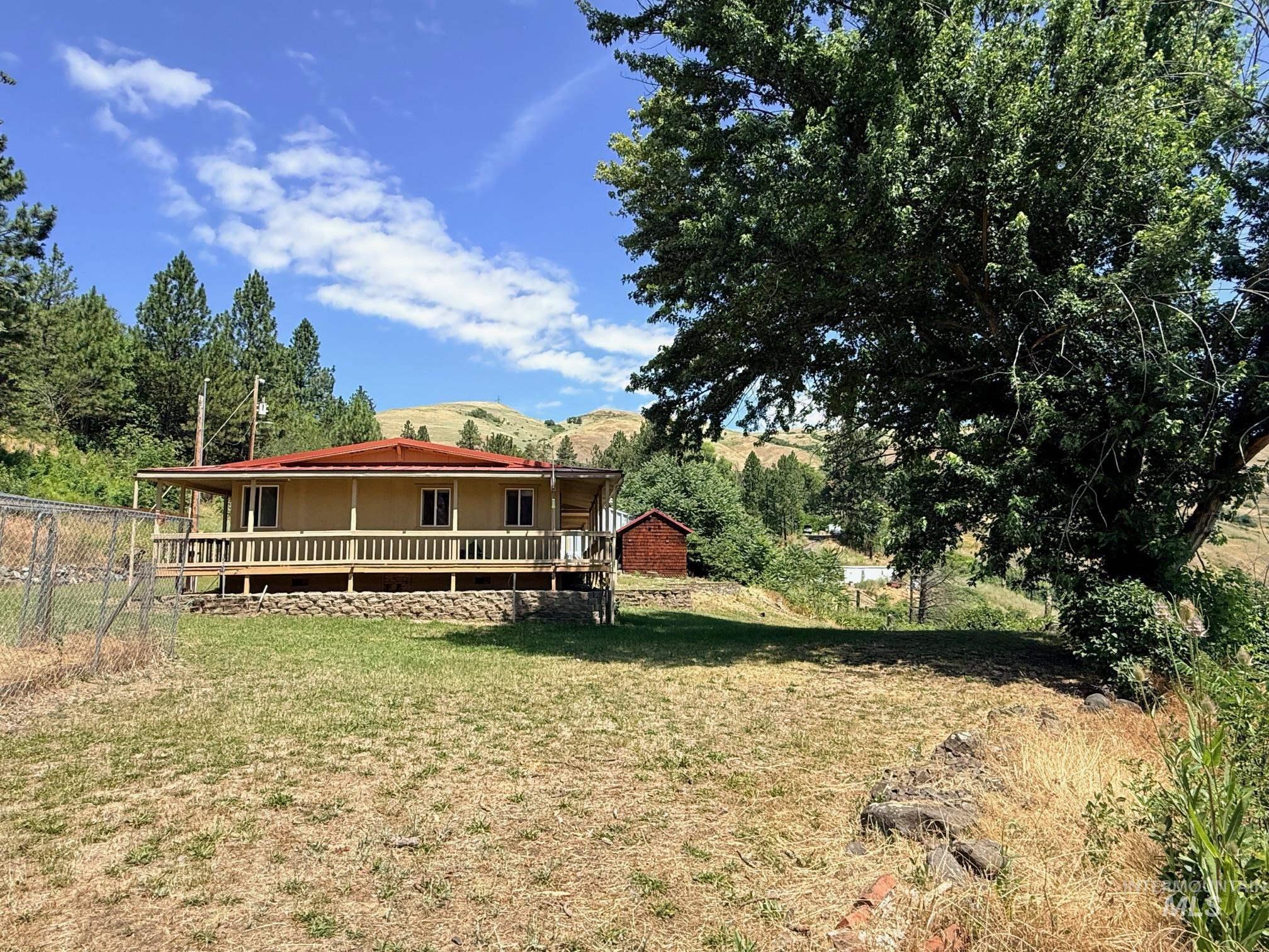 35322 River Road Lenore, ID 83541 - Photo 35 of 42 Ranch-style residence featuring a full-width covered porch, a red metal roof, and light-colored siding
