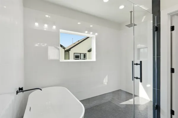 a bathroom with a bathtub and shower