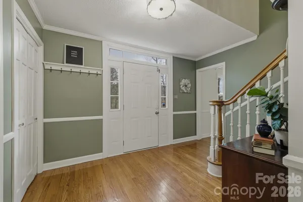 a kitchen with granite countertop a table chairs stove and cabinets