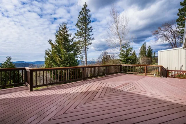 a view of balcony with wooden floor and fence