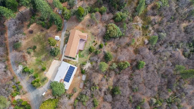 an aerial view of a house with a yard