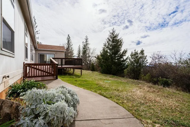 a view of a house with backyard and sitting area