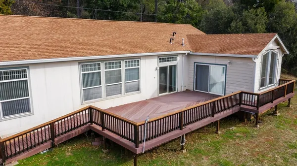 a view of a house with wooden floor roof and wooden fence