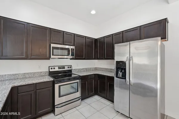 a kitchen with a refrigerator sink and microwave