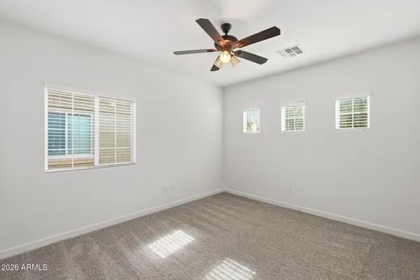 a view of a big room with wooden floor closet and windows