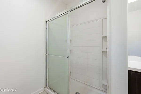 a bathroom with a glass shower door
