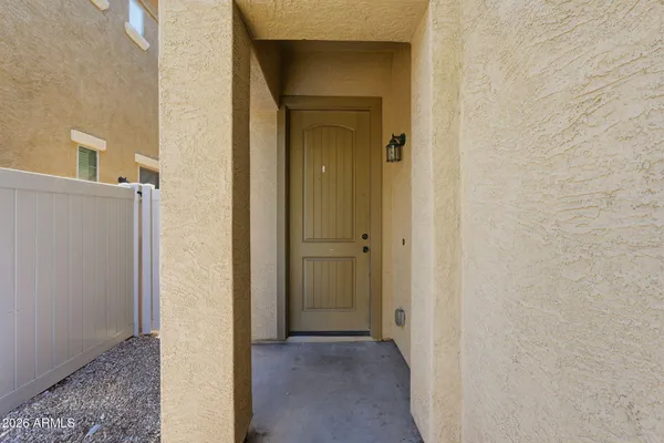 a view of a hallway with a wooden door