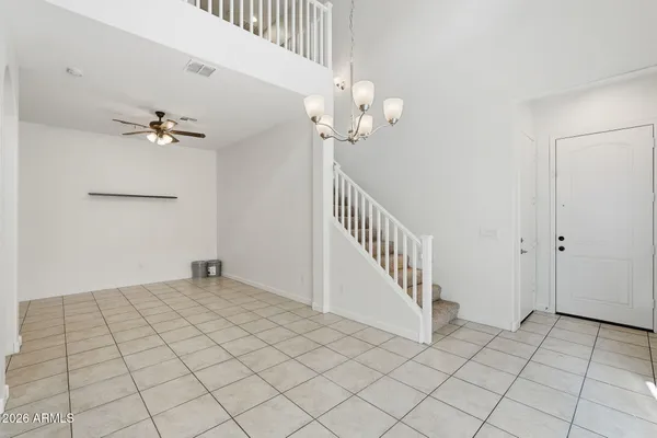 a view of a chandelier fan and entryway