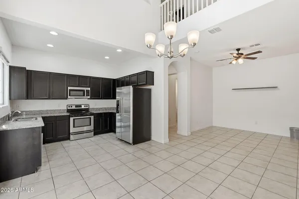 a kitchen with stainless steel appliances a refrigerator sink and microwave