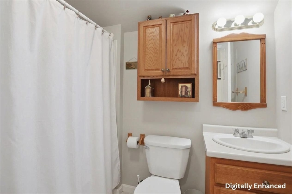 186 Common Street Groton, MA 01450 - Photo 19 of 28 a bathroom with a toilet a sink and a mirror