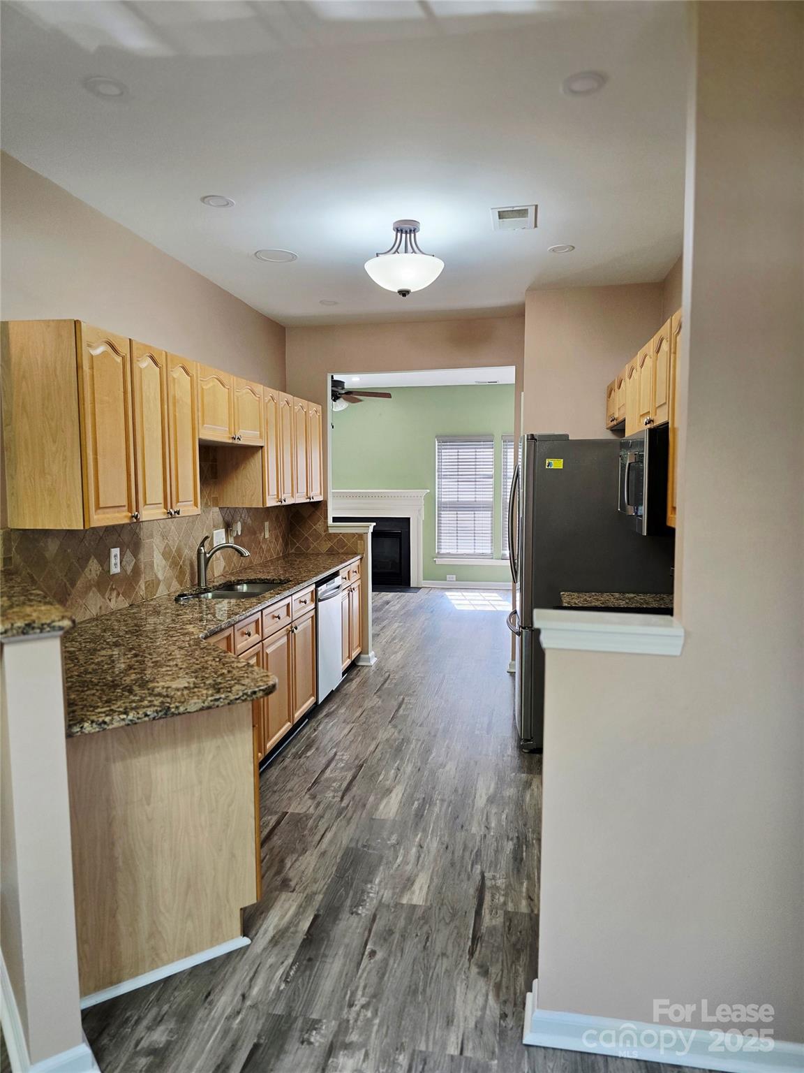 19025 Coachmans Trace Cornelius, NC 28031 - Photo 11 of 34 a kitchen with stainless steel appliances granite countertop a stove a sink and a refrigerator