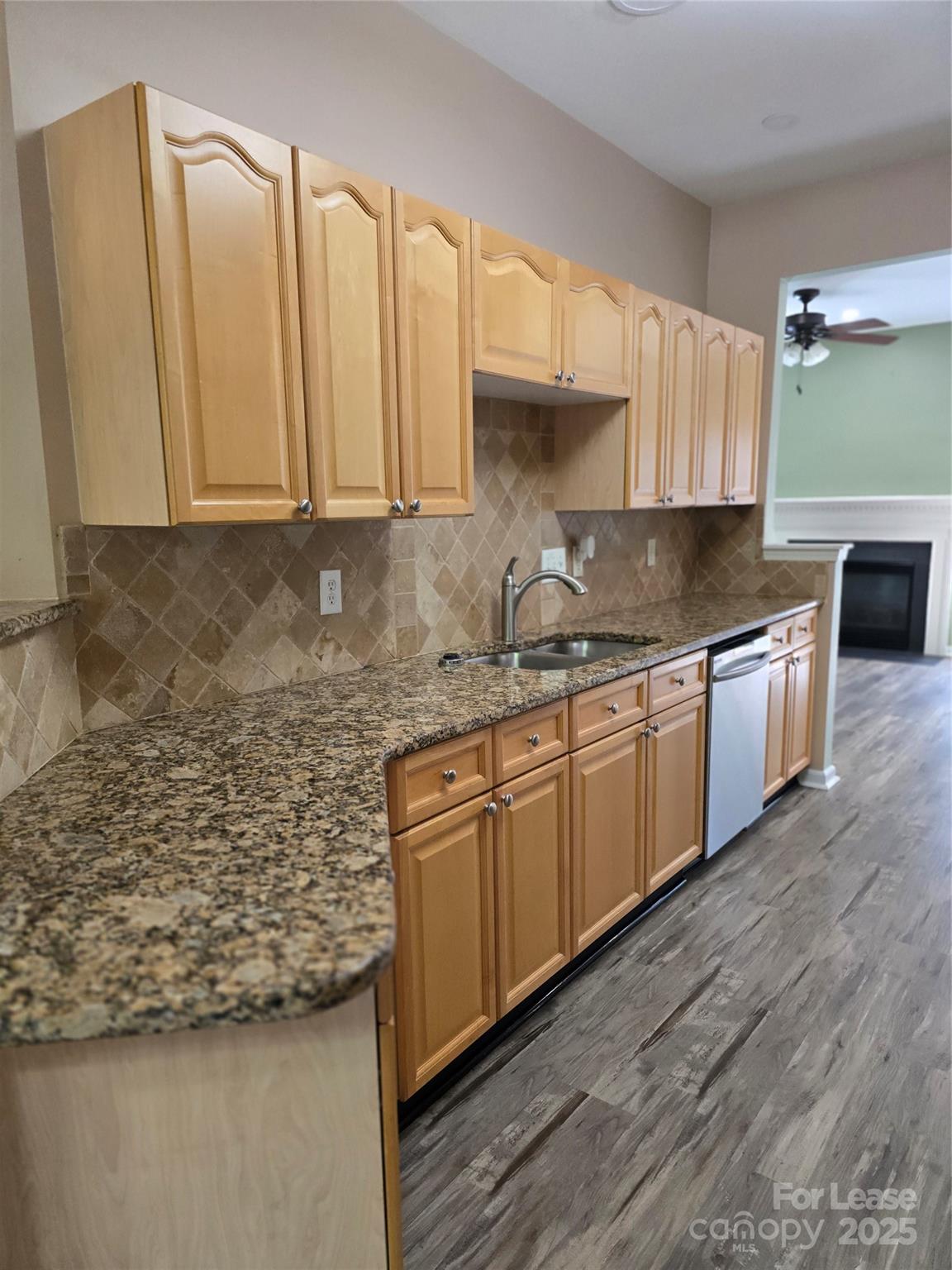 19025 Coachmans Trace Cornelius, NC 28031 - Photo 14 of 34 a kitchen with stainless steel appliances granite countertop a sink a stove and a refrigerator
