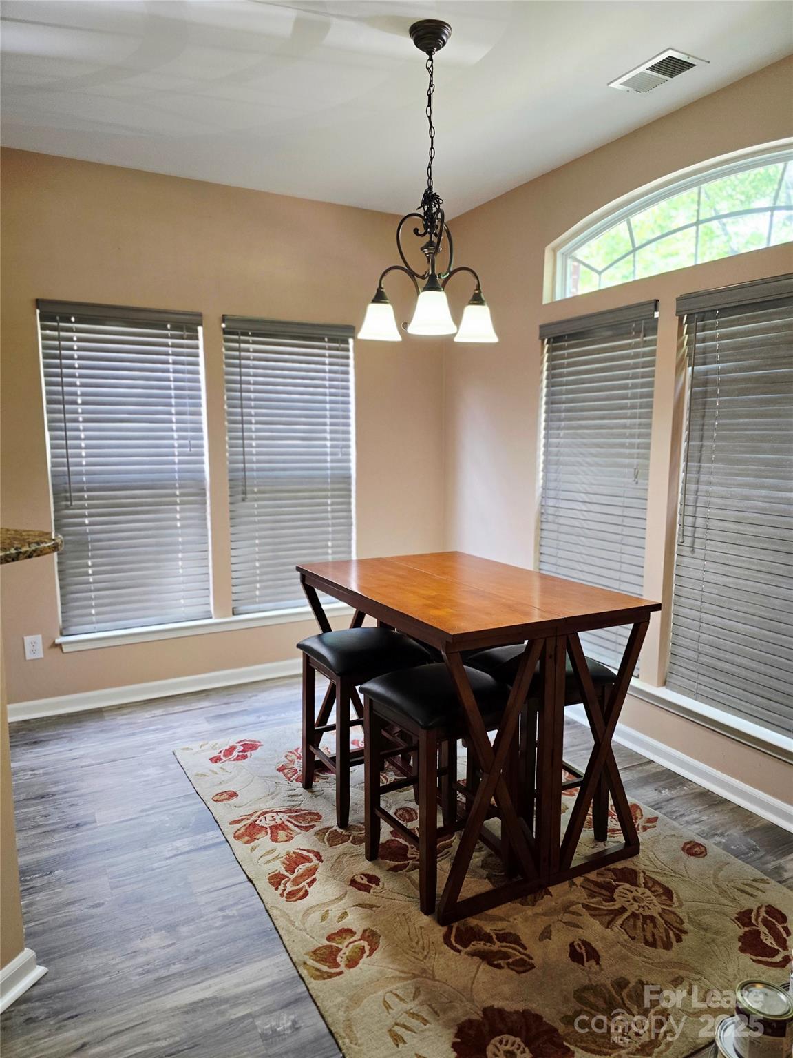 19025 Coachmans Trace Cornelius, NC 28031 - Photo 15 of 34 a view of a dining room with furniture window and wooden floor