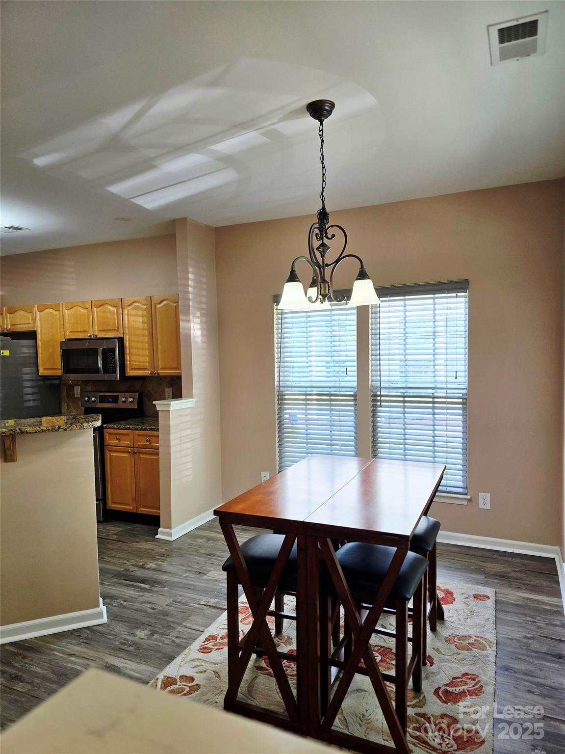 19025 Coachmans Trace Cornelius, NC 28031 - Photo 16 of 34 a view of a dining room with furniture window and wooden floor