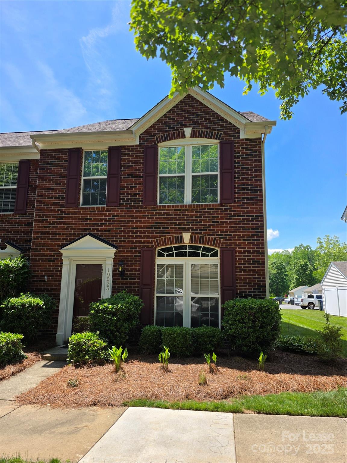 19025 Coachmans Trace Cornelius, NC 28031 - Photo 2 of 34 a front view of a house with a yard and potted plants