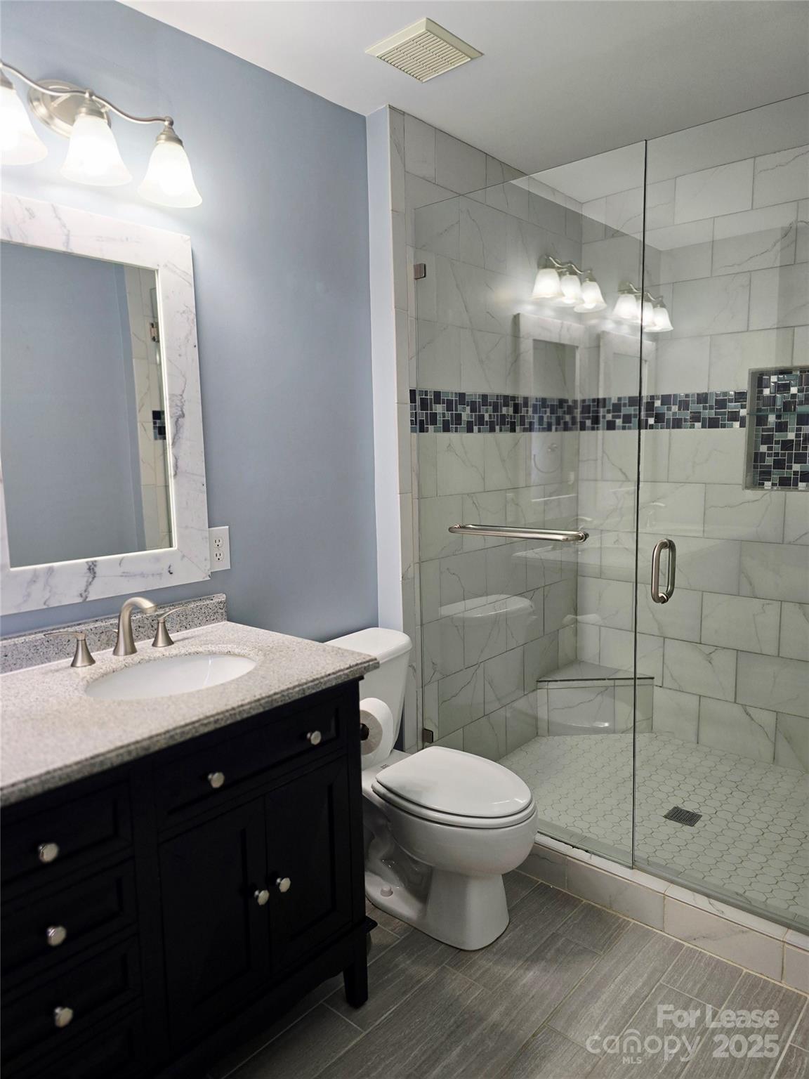 19025 Coachmans Trace Cornelius, NC 28031 - Photo 21 of 34 a bathroom with a toilet sink and shower