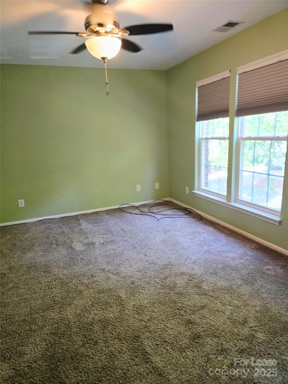 19025 Coachmans Trace Cornelius, NC 28031 - Photo 23 of 34 a view of a room with a window and a ceiling fan