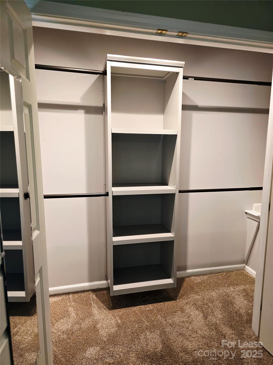 19025 Coachmans Trace Cornelius, NC 28031 - Photo 25 of 34 a view of walk in closet with wooden floor