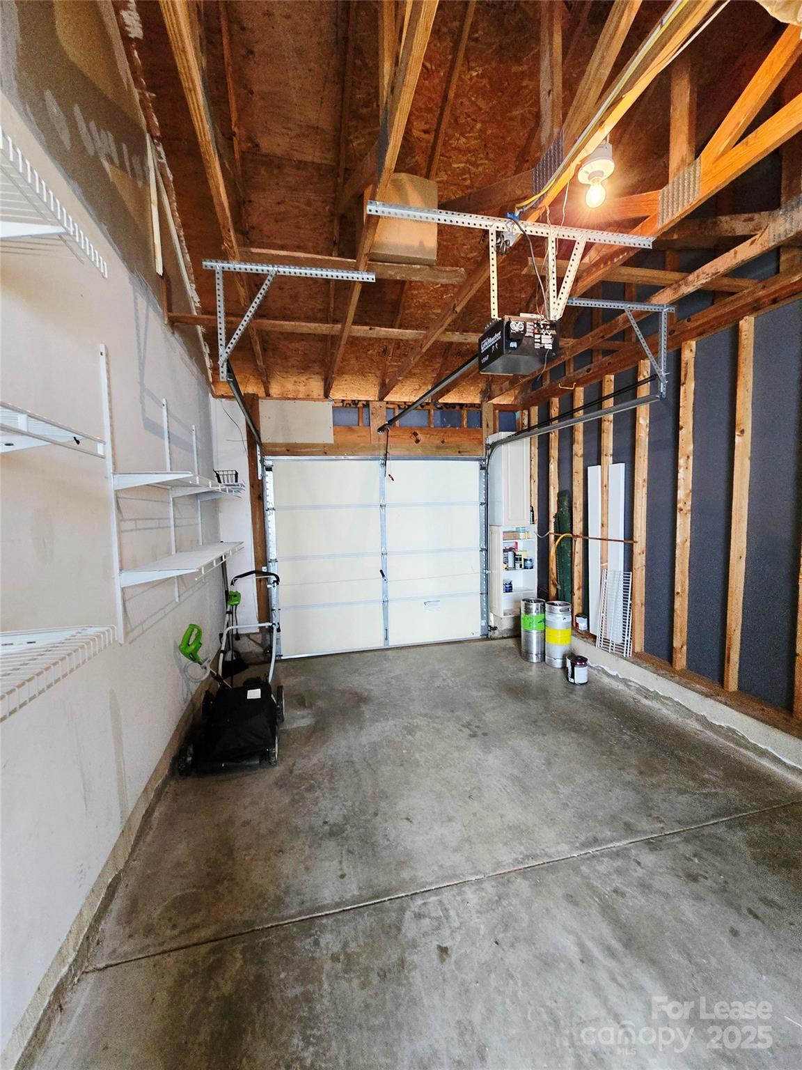19025 Coachmans Trace Cornelius, NC 28031 - Photo 33 of 34 a view of a garage with wooden table and chairs