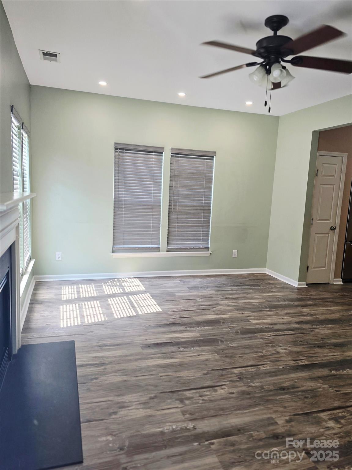 19025 Coachmans Trace Cornelius, NC 28031 - Photo 7 of 34 a view of an empty room with a window and a ceiling fan