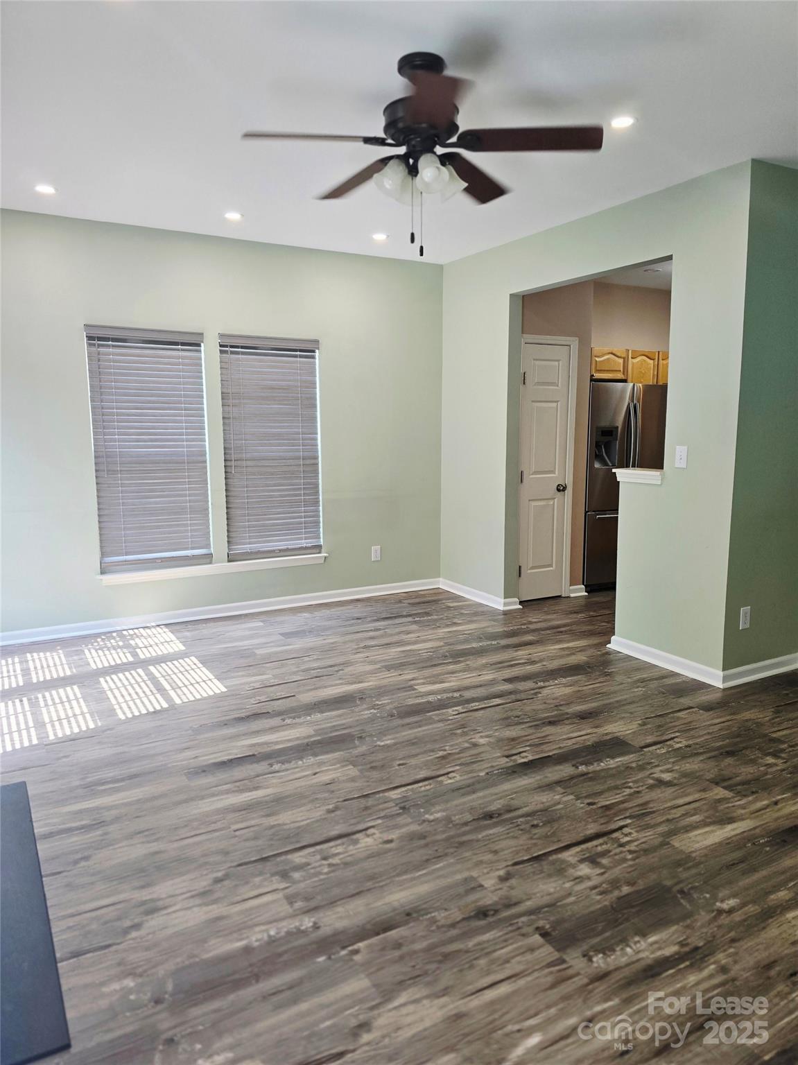 19025 Coachmans Trace Cornelius, NC 28031 - Photo 8 of 34 a view of an empty room and window and wooden floor