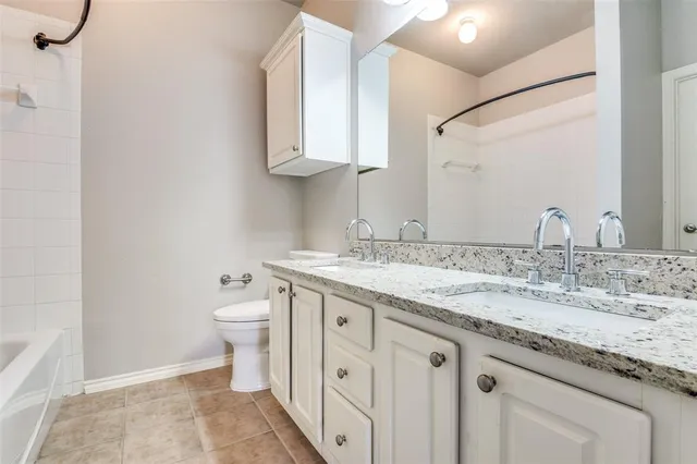 an empty room with chandelier fan