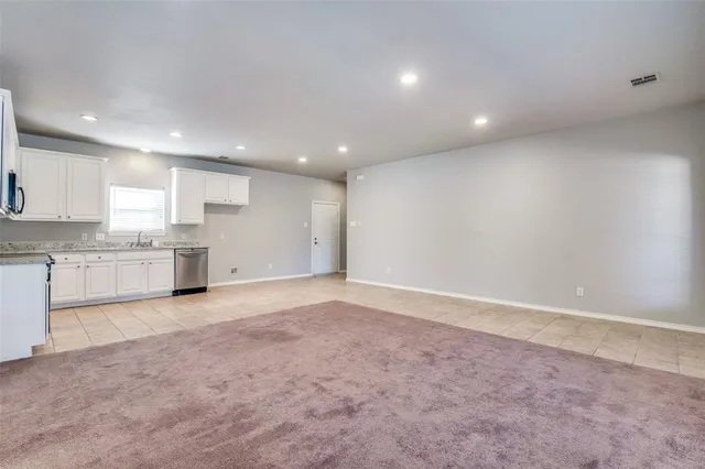 a view of a kitchen with a sink and a window