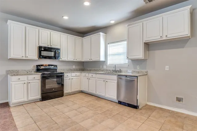 a view of kitchen with refrigerator and window