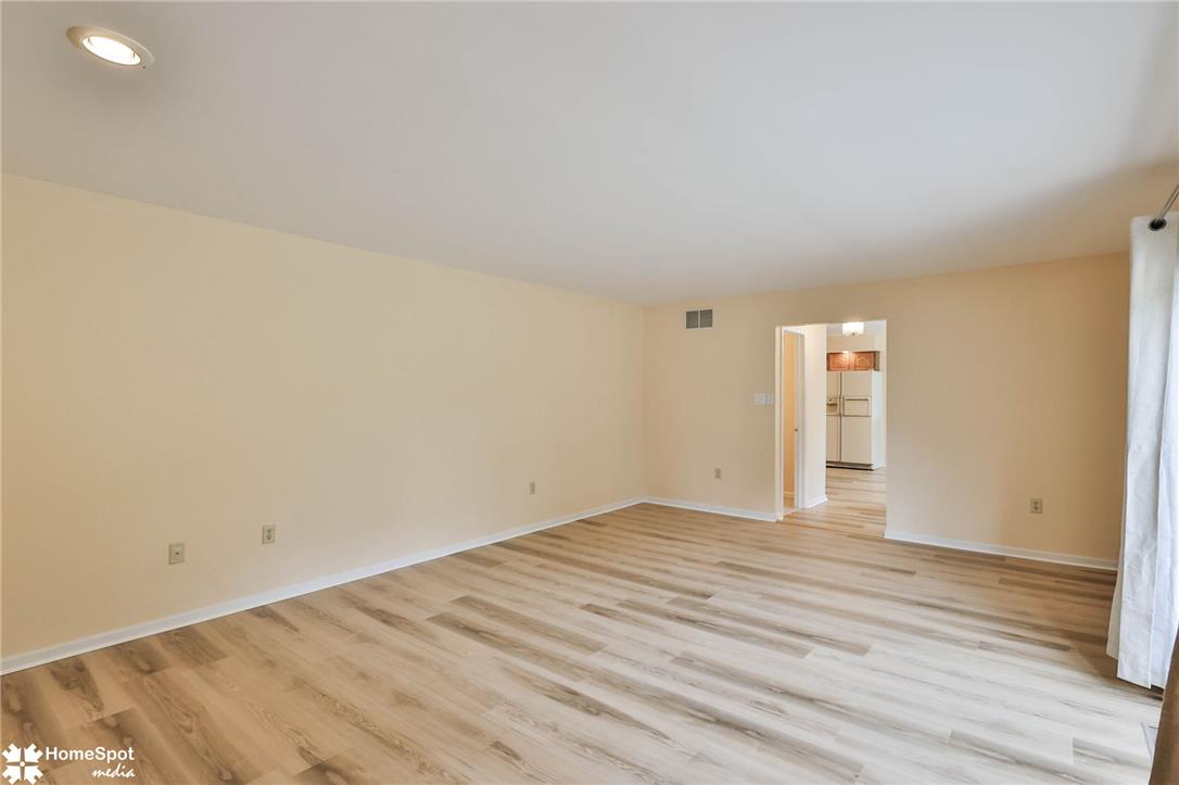 4059 Wedgewood Road Allentown, PA 18104 - Photo 28 of 72 Natural wood flooring complements this inviting living space, connecting to a bright kitchen.
