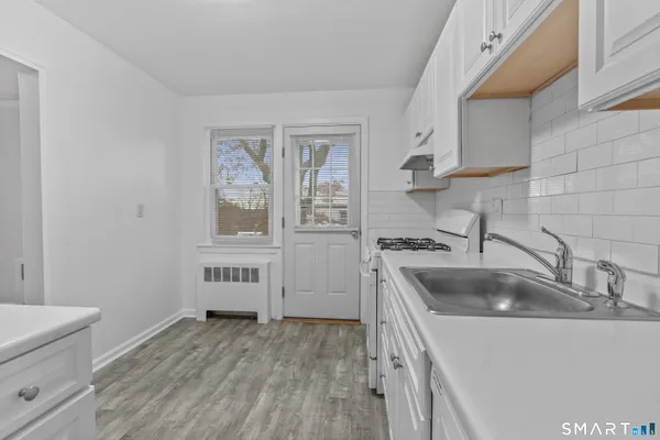 a kitchen that has a sink and a stove