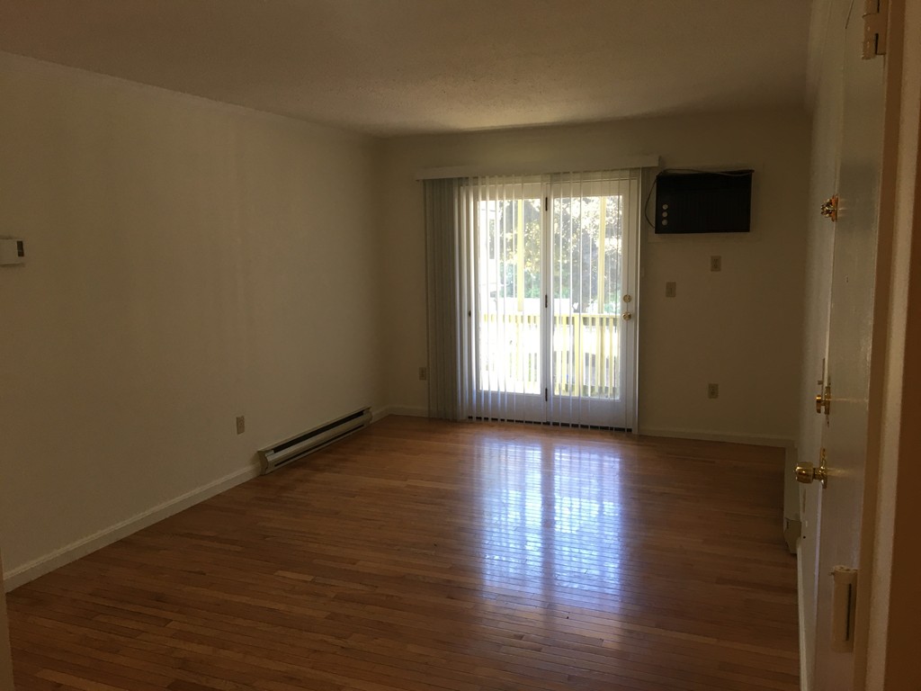 30 Abbey Road, Unit 202 Leominster, MA 01453 - Photo 4 of 10 a view of an empty room with wooden floor and a window