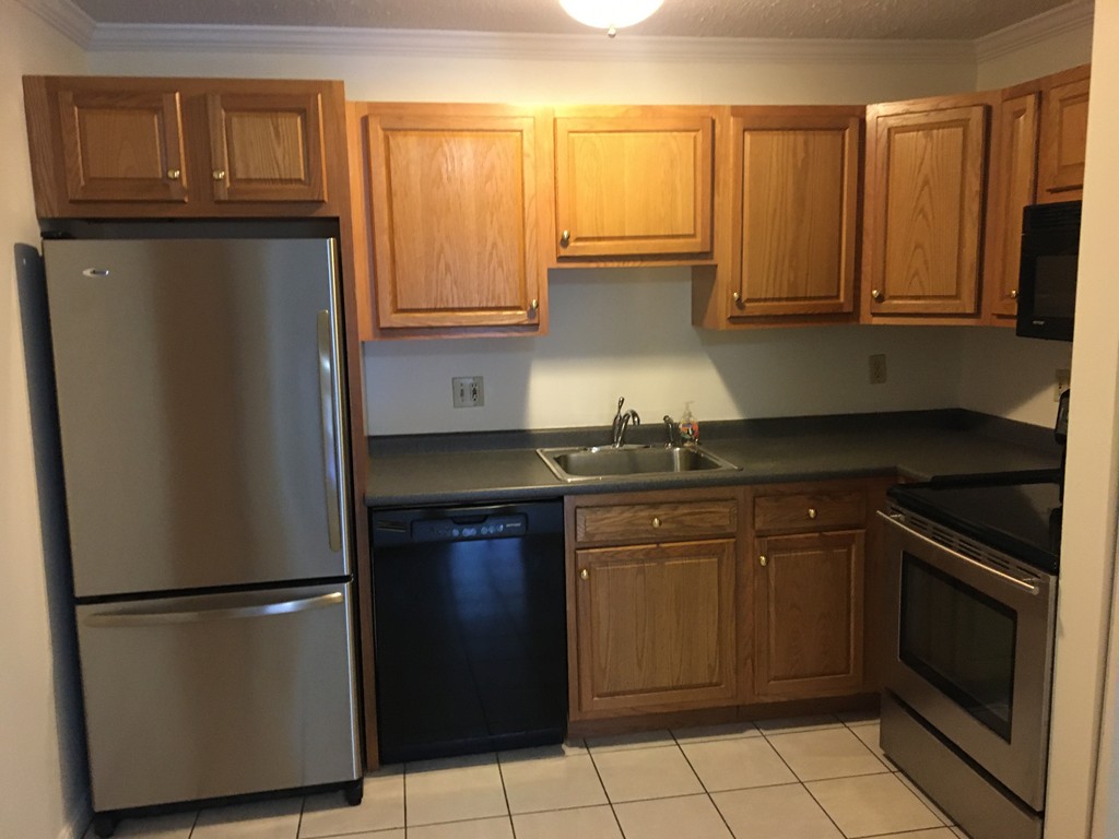 30 Abbey Road, Unit 202 Leominster, MA 01453 - Photo 7 of 10 a kitchen with granite countertop a refrigerator and a sink