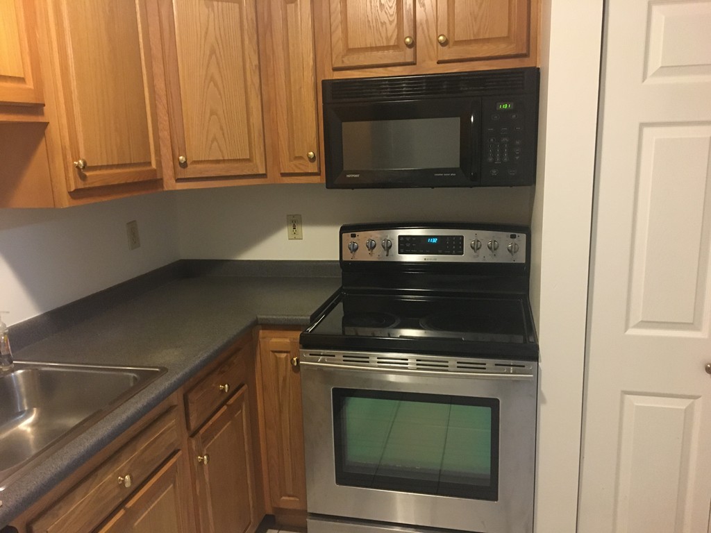 30 Abbey Road, Unit 202 Leominster, MA 01453 - Photo 10 of 10 a stove top oven sitting inside of a kitchen