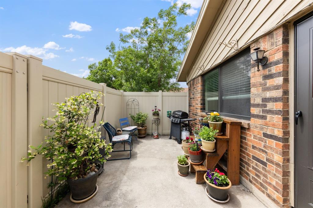 2240 Tarpley Road, Unit 411 Carrollton, TX 75006 - Photo 20 of 28 a view of a backyard with chair and potted plants