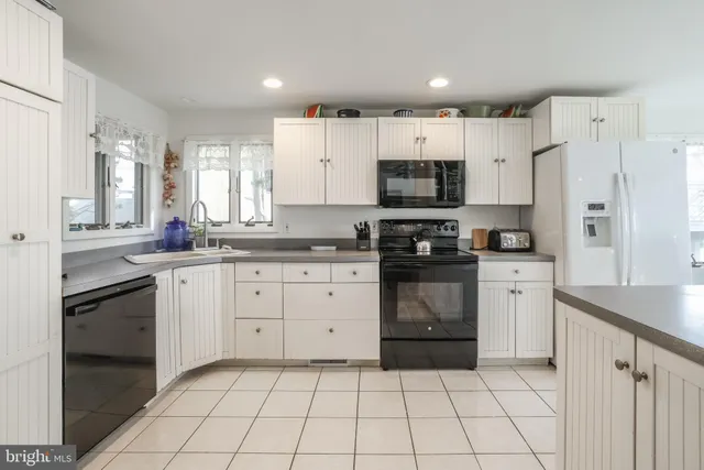 a kitchen with a sink a stove and refrigerator