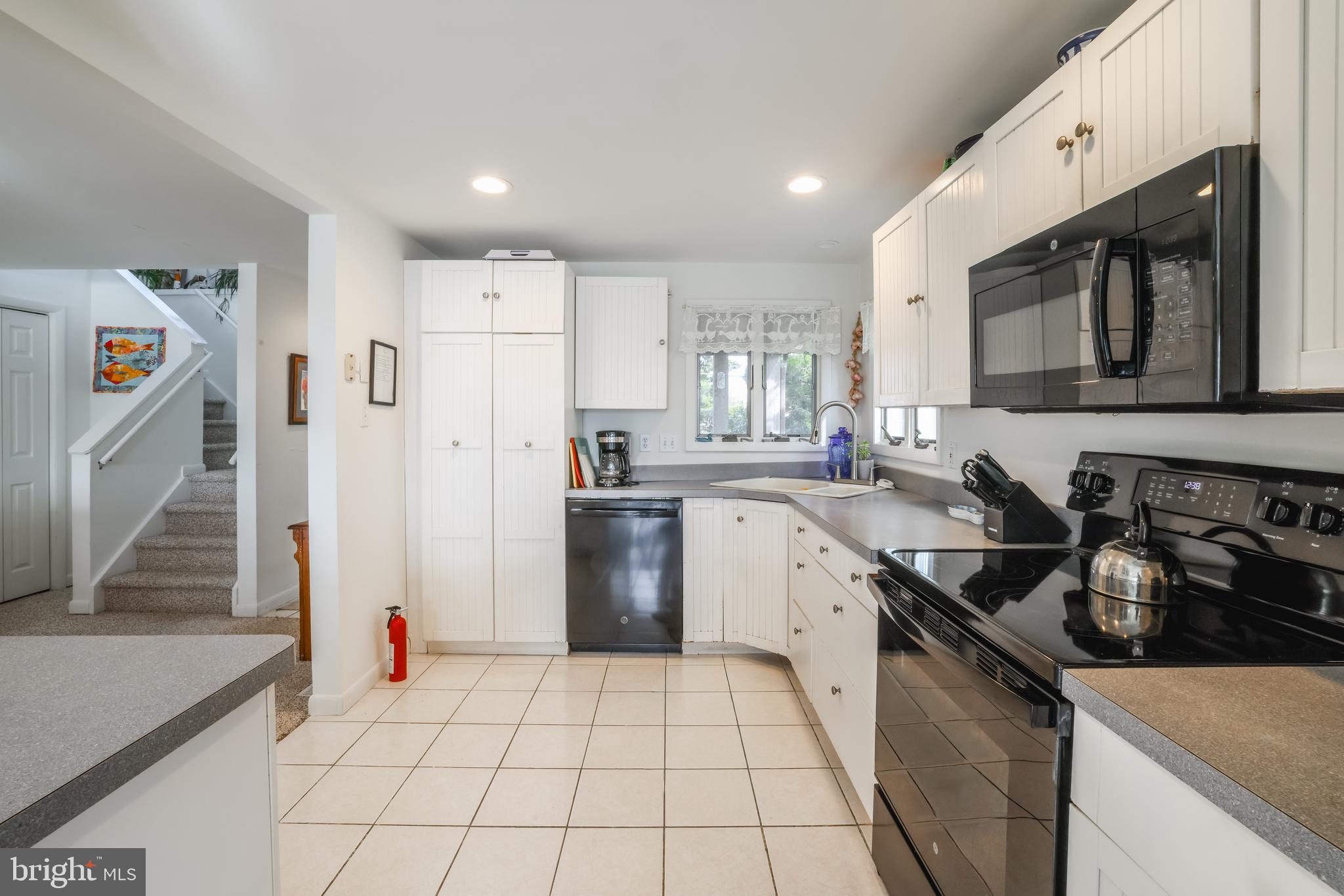 24 Maiden Lane Harvey Cedars, NJ 08008 - Photo 12 of 37 a kitchen with a sink a stove and refrigerator