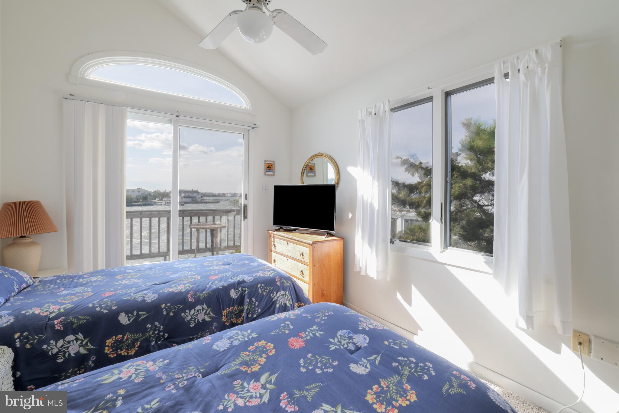 24 Maiden Lane Harvey Cedars, NJ 08008 - Photo 30 of 37 a bedroom with a large bed and a window
