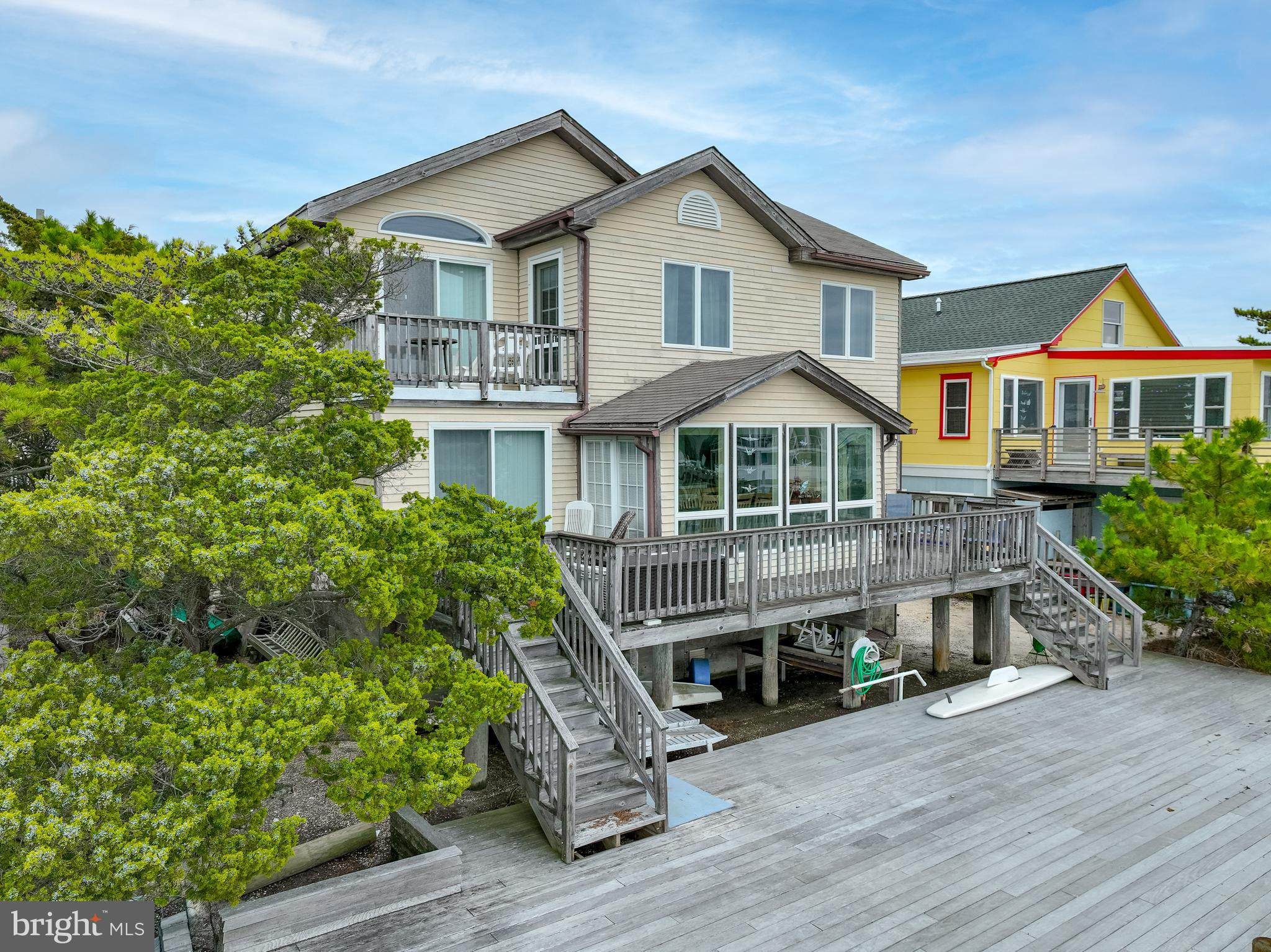 24 Maiden Lane Harvey Cedars, NJ 08008 - Photo 3 of 37 a front view of a house with a yard and potted plants