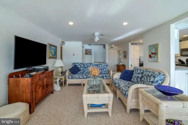 a living room with furniture and kitchen view