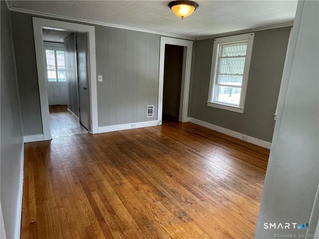 61 8th Street Derby, CT 06418 - Photo 6 of 12 an empty room with wooden floor and windows