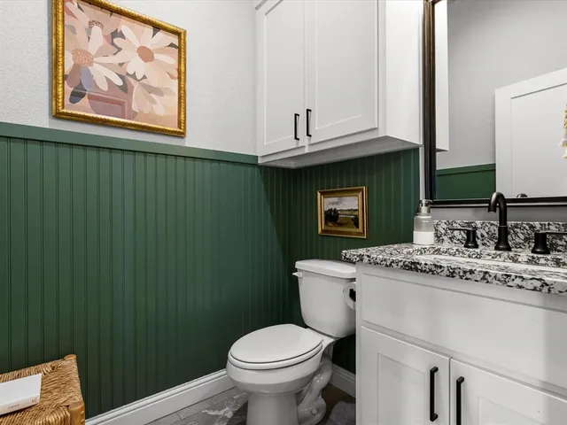 a bathroom with a toilet sink and mirror