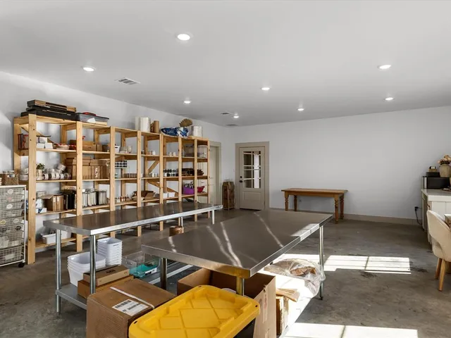 a living room with a gaming tables and a book shelf