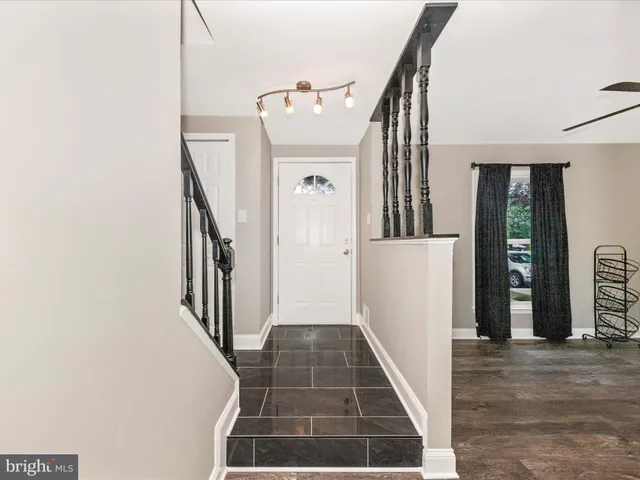 a view of a hallway with windows and stairs