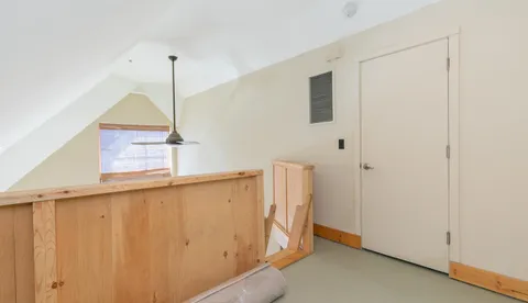 a view of a hallway with stairs