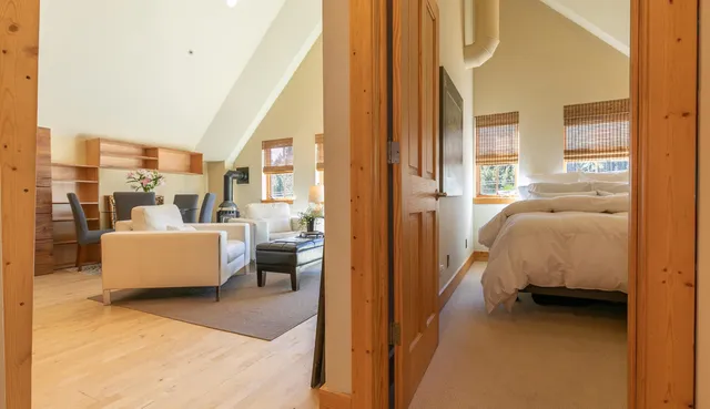 a bedroom with furniture and a large window