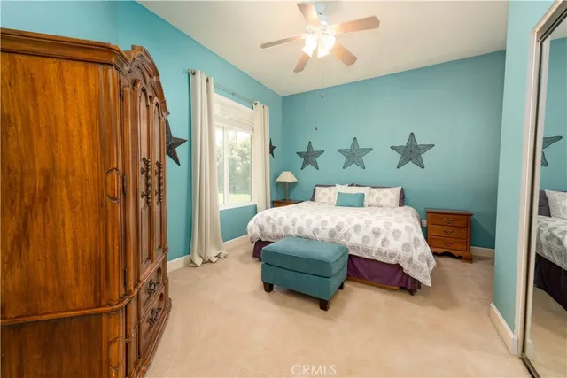 a bedroom with a bed dresser and a window