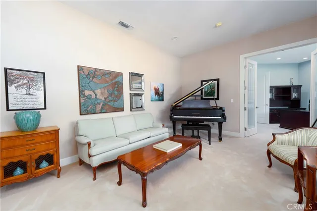 a living room with furniture and a piano